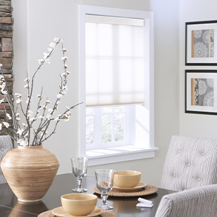 Window with honeycomb shade in a traditional dining room.