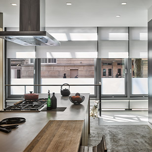 Window wall with roller shades in a urban, modern kitchen.