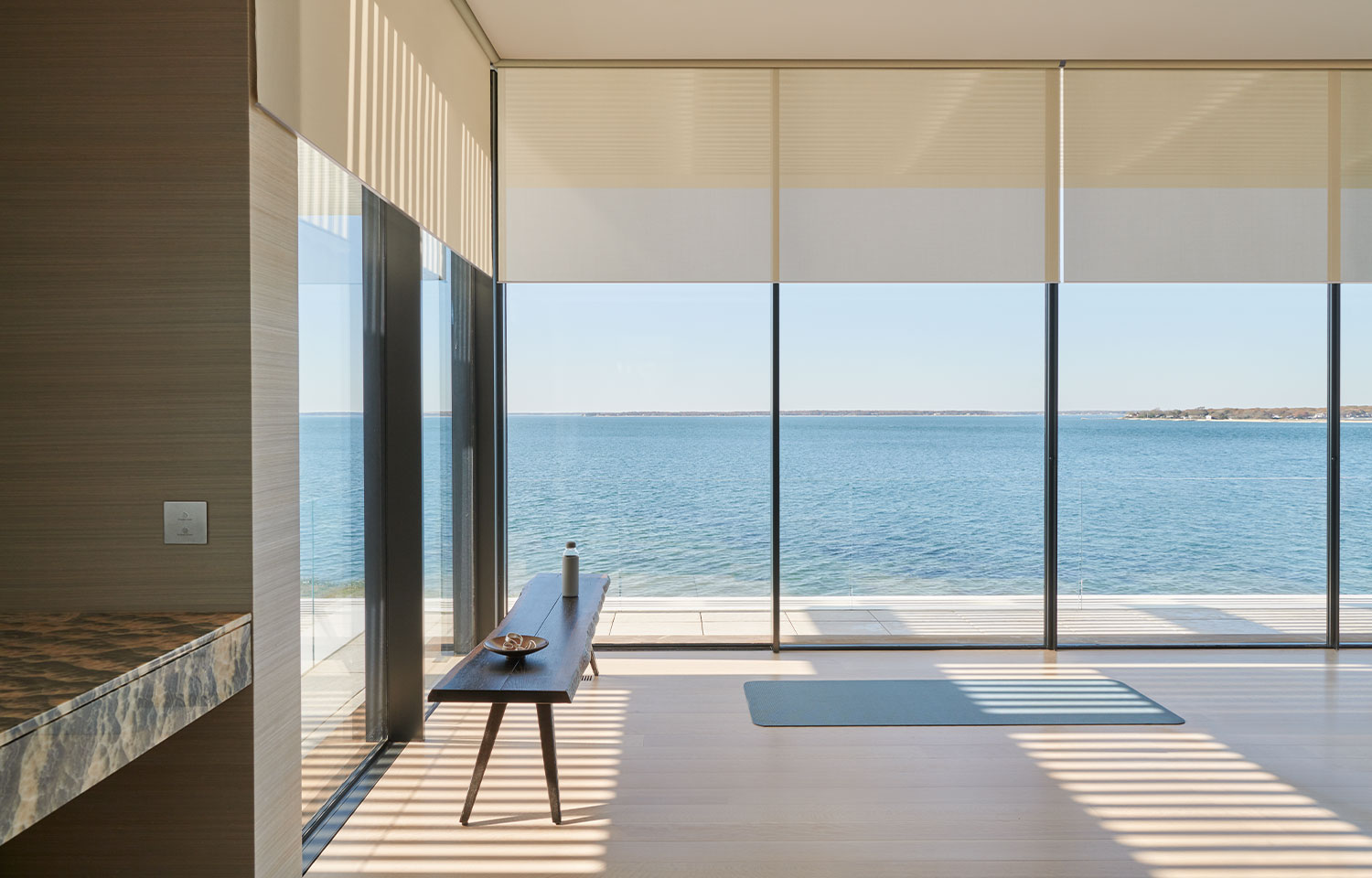 A residential studio with automated shades powered by a HomeWorks Control System